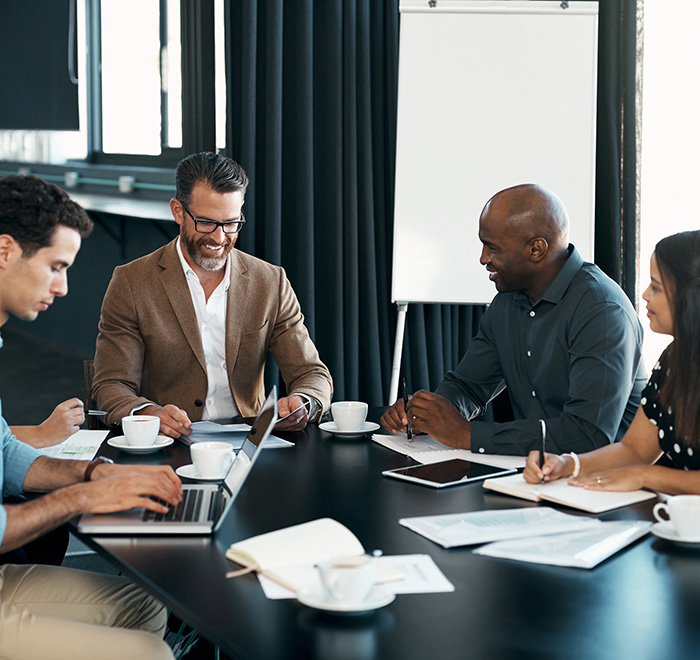 Group of four people around a table working together