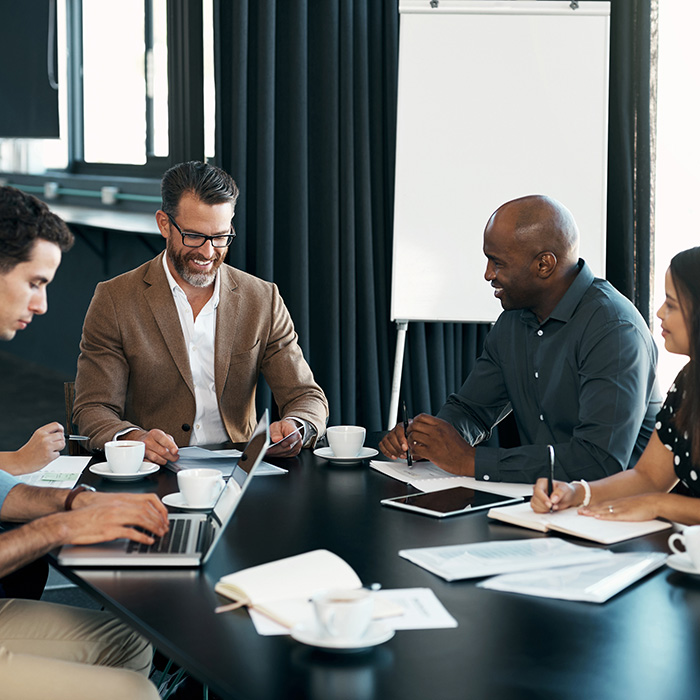 Group of four people around a table working together