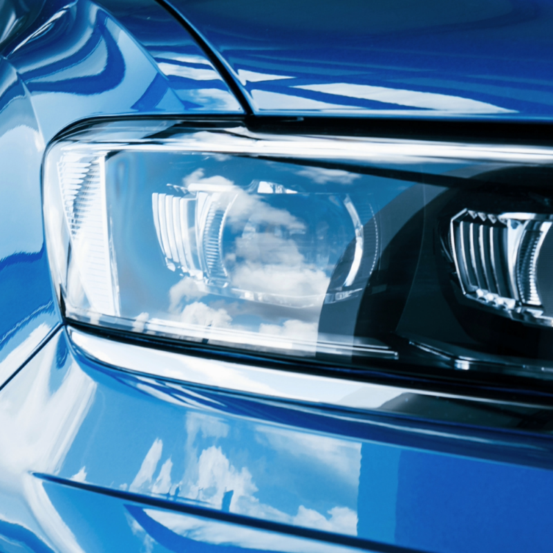 Close up of a blue vehicle's headlights