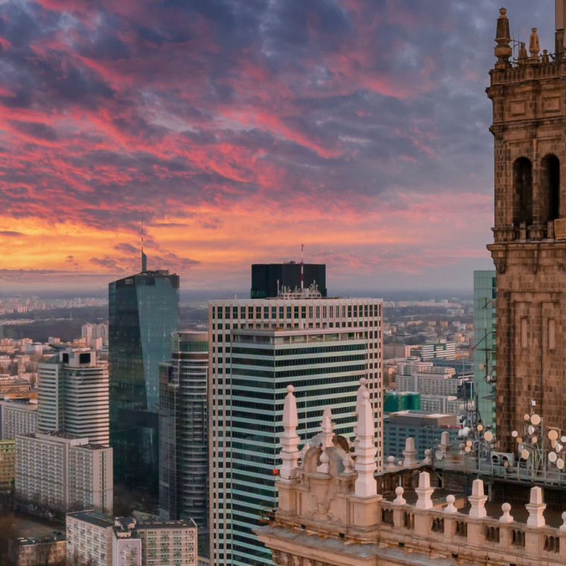 Skyscraper clocktower and city skyline at dusk